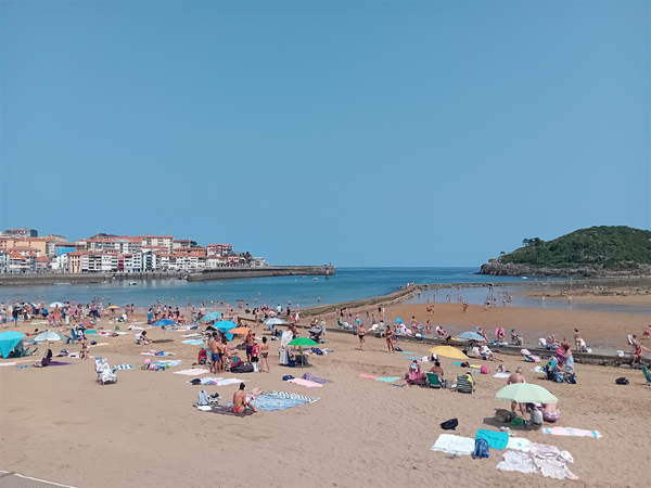 Beautiful Isuntza beach at low tide, with the old buildings of Lekeitio on the right and the causeway stretching out to the island on the right. I took this from the terrace above the beach.