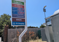 Image of  signage for Esso filling station with fuel prices and signs for Londis, Costa and EV charging.