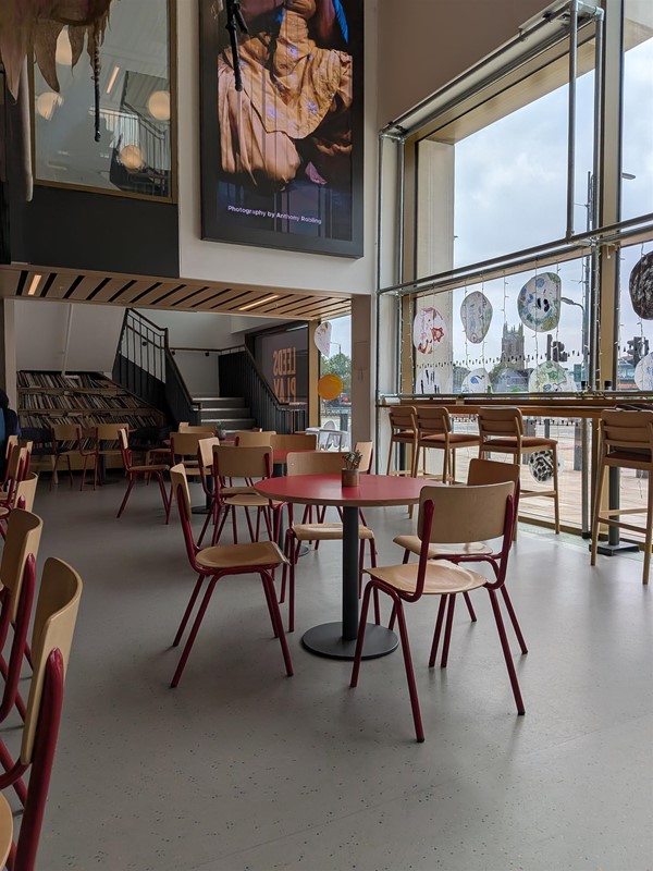 image of tables and chairs and bar-height seating along the windows