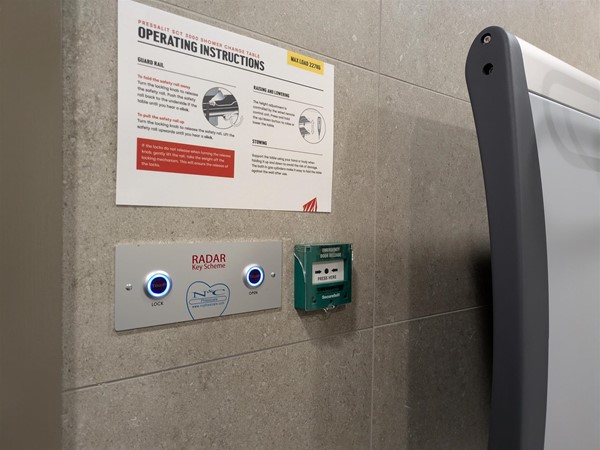 Image of door lock mechanism, two buttons on a wall