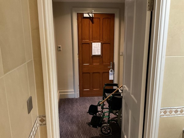 Picture of a room doorway with a wheelchair outside