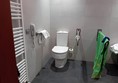 Image of a bathroom with a toilet and towel rack