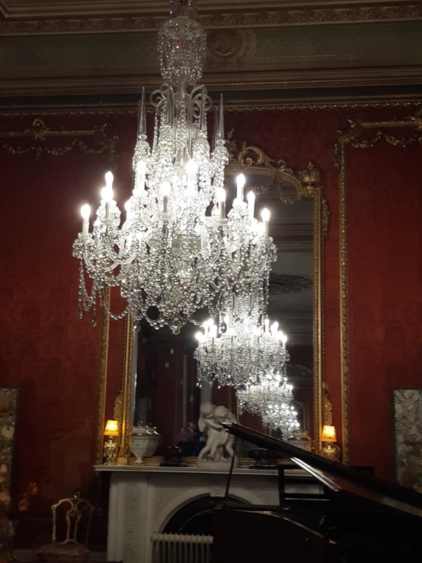 Picture of a chandelier in front of a mirror