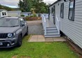 If you're not in wheelchair friendly accommodation but are partially ambulant, vans with verandahs have steps with rails on both sides. Vans without verandahs only have one (or no) rail.