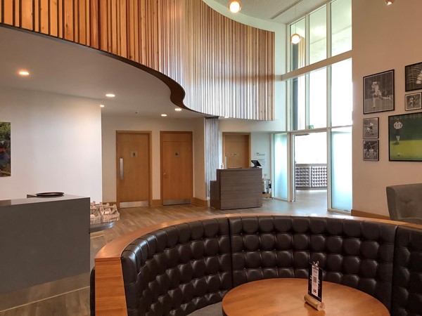 Picture of a seating booth with toilet doors visible in the background