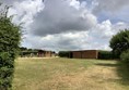 Field with wooden huts