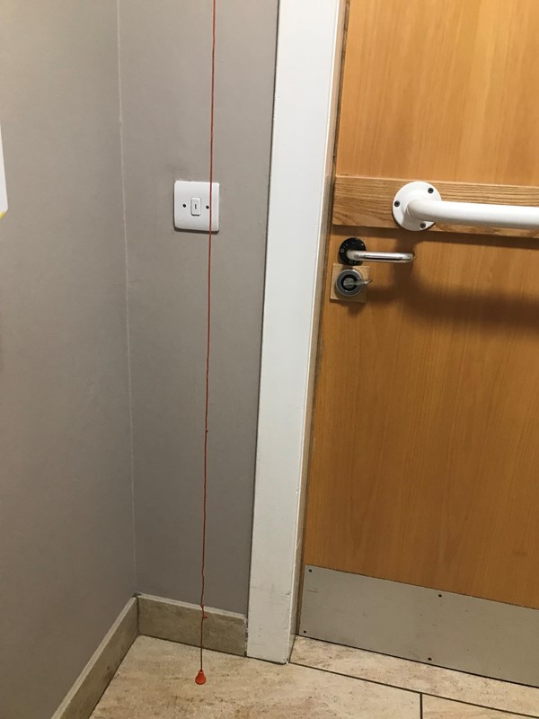 Red cord hanging to the floor