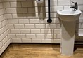 Image of sink, handrail and handryer in bathroom
