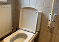 Image of a toilet and grab rail