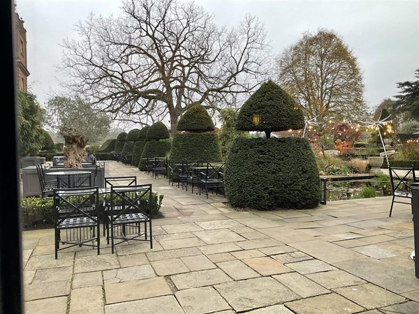 Image of a paved area with tables and chairs