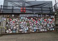 Image of the shrine, white letters on a black sign read "Ianto's Shrine" and there are plenty of pictures and tributes.