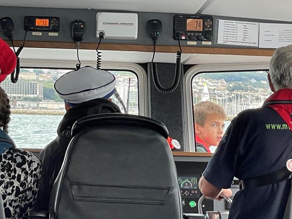 One of our grandsons driving the boat