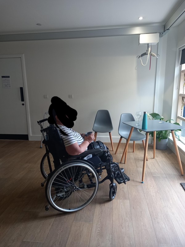 Wheelchair user by a table