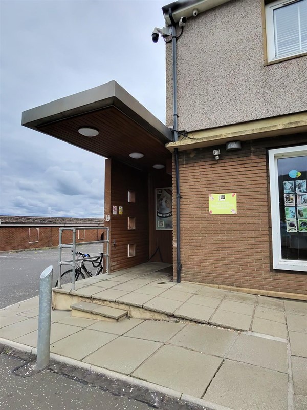 Ramp to the entrance. The blue badge parking bay is to the left.