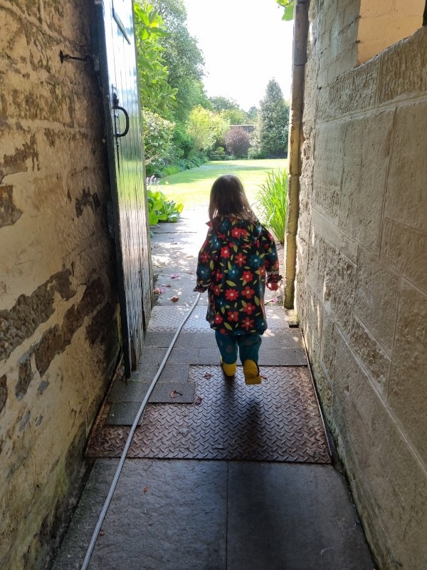 Route from cobbled courtyard to gardens (and young child for scale)