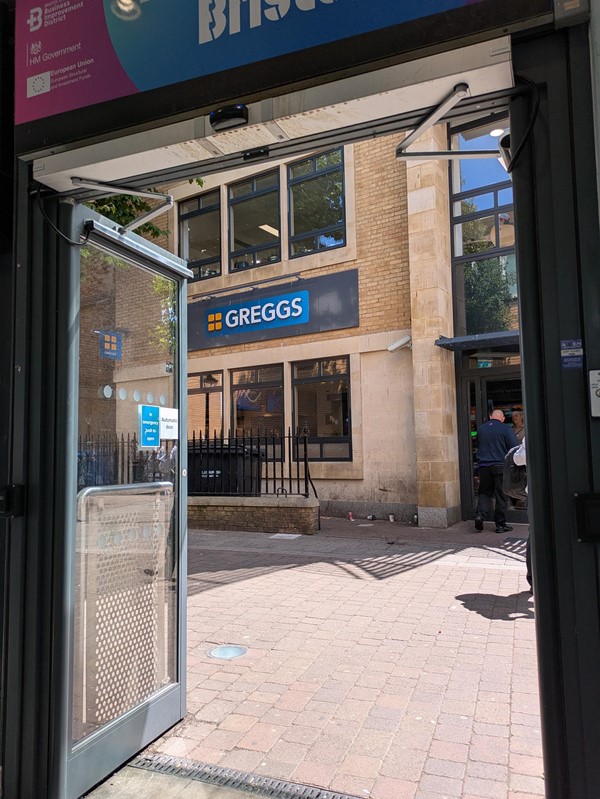 Image of alternative entrace with automatic doors - there's a Greggs outside