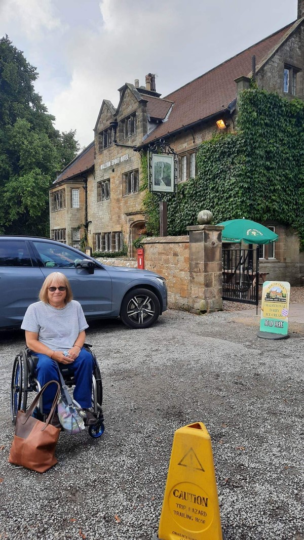 Picture of a person in a wheelchair in the carpark at The Mallyan Spout Hotel