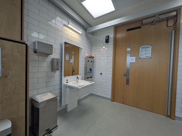 Image of sink and door to accessible toilet