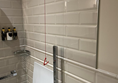 Image shows another angle in the wetroom- style in a bathroom in an accessible room at The Grand Hotel, Birmingham. 

There is a red emergency cord hanging from the ceiling but in this picture it does not reach the floor.