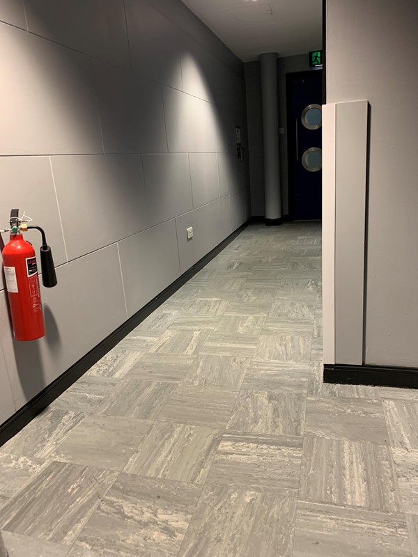 View of corridor from accessible toilet to door