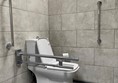 Loo with grab rails.