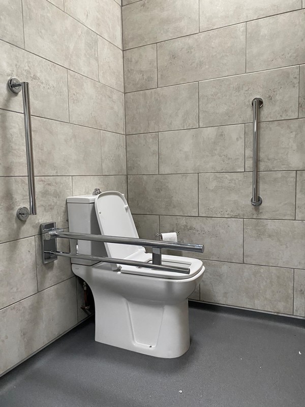 Loo with grab rails.