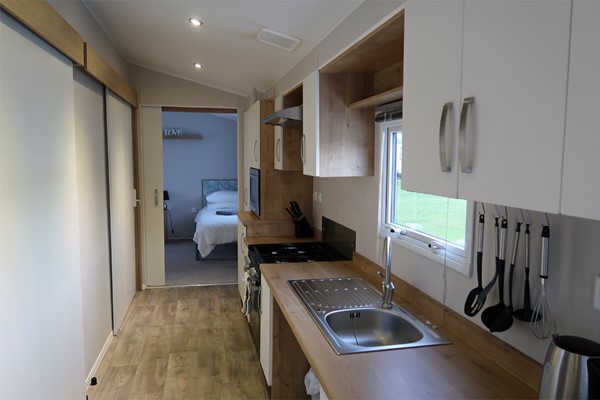 Accessible kitchen with lowered sink, cooker and microwave.