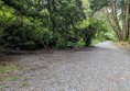 A photo of the terrain

A forest with a gravel path, sloping downhill.