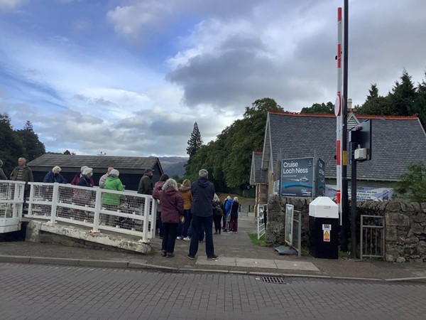 Image of people queueing to get onto a LOch Ness tour boat