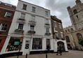 The shop as seen from Trinity Street, the step-free entrance is on the right-hand side within the white arch.