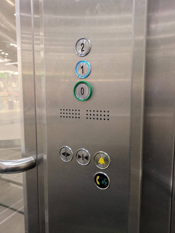Image of lift access. The lift buttons have braille markings