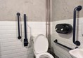 image of accessible toilet, and contrasting grab rails