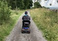 Image of a wheelchair use on a path