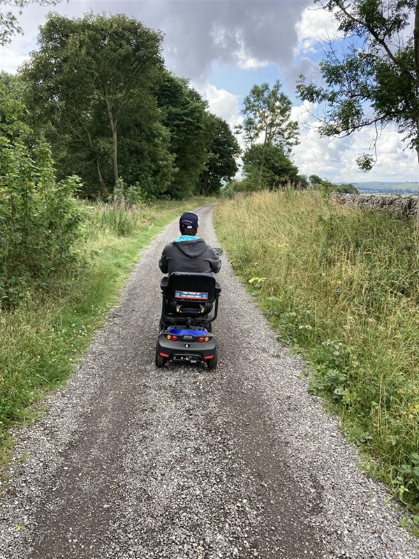 Image of a wheelchair use on a path