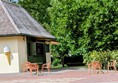 Image of the kiosk from far away with tables and chairs outside