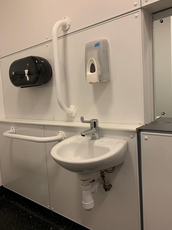 Image of sink , showing shelf space at the back and space to roll under