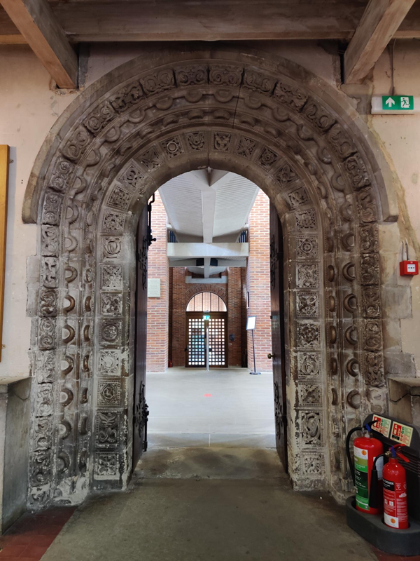 A very ancient Norman stone doorway, now leading to the modern extension on the south side of the cathedral.