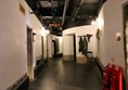 Inside the prison corridor with cell doors off it.