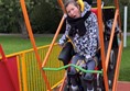 Picture of someone using the wheelchair accessible swing