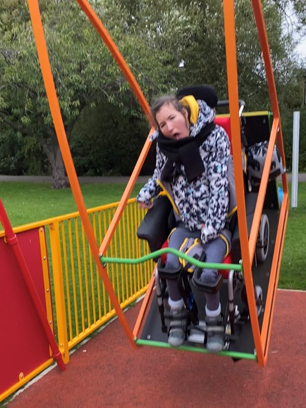 Picture of someone using the wheelchair accessible swing