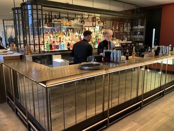 Image of two people at a bar.
