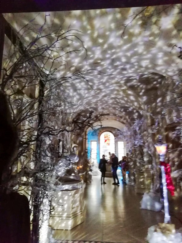 Corridor into Narnia with light display simulating snow.