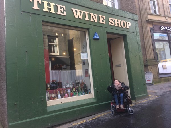 Image showing the outside of The Wine Shop with Claire outside.