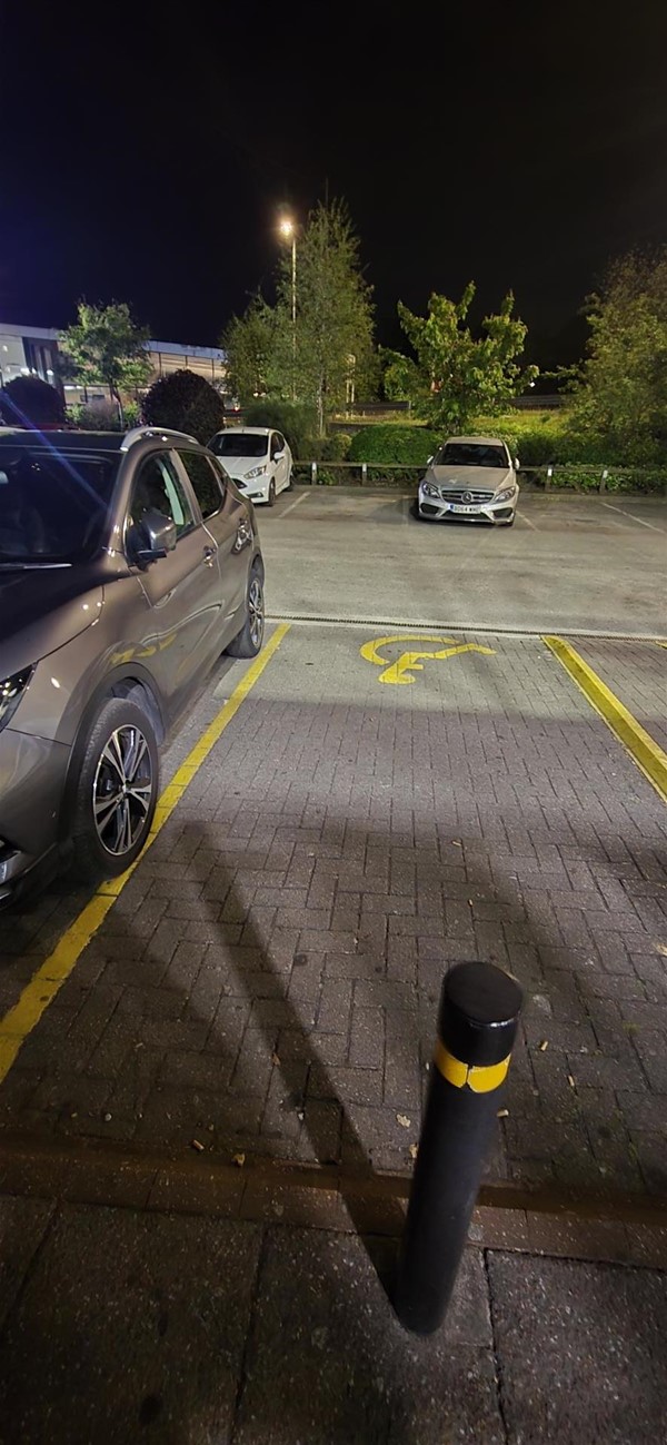Image of a bollard and disabled parking space