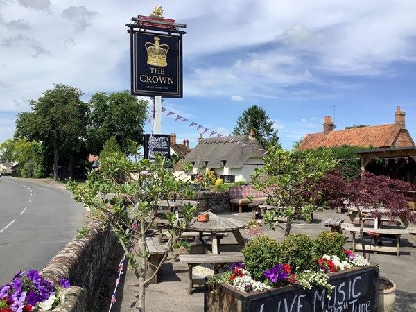 Picture of The Crown pub sign overlooking a beer garden