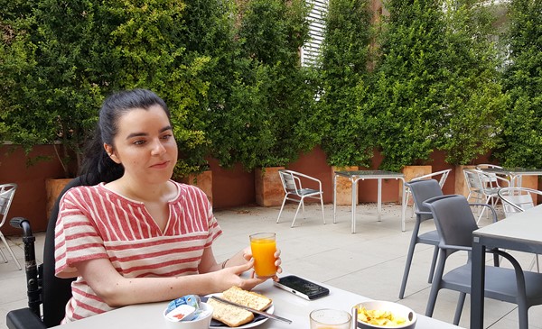 outdoor dining terrace wheelchair user eating breakfast