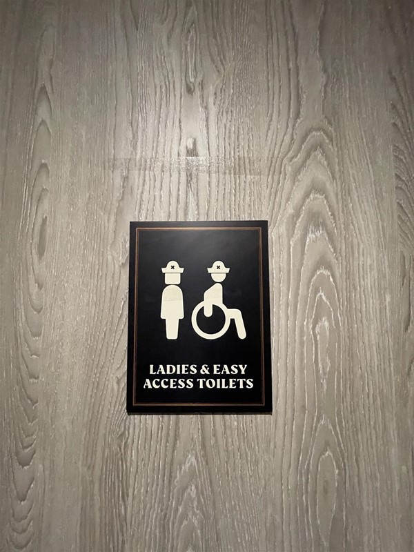 Image of a "Ladies and easy access toilet" sign