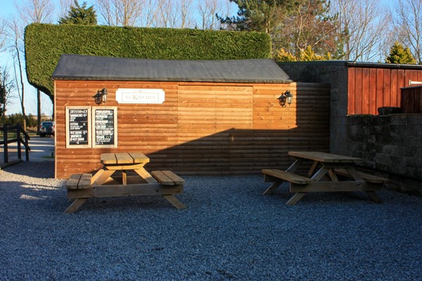 Pizza hut which is closed in the photo but opens through large hatch. Area in front is quite clear but thick gravel surface.