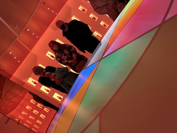 Visitors standing around the circular flavours table in the flavours room