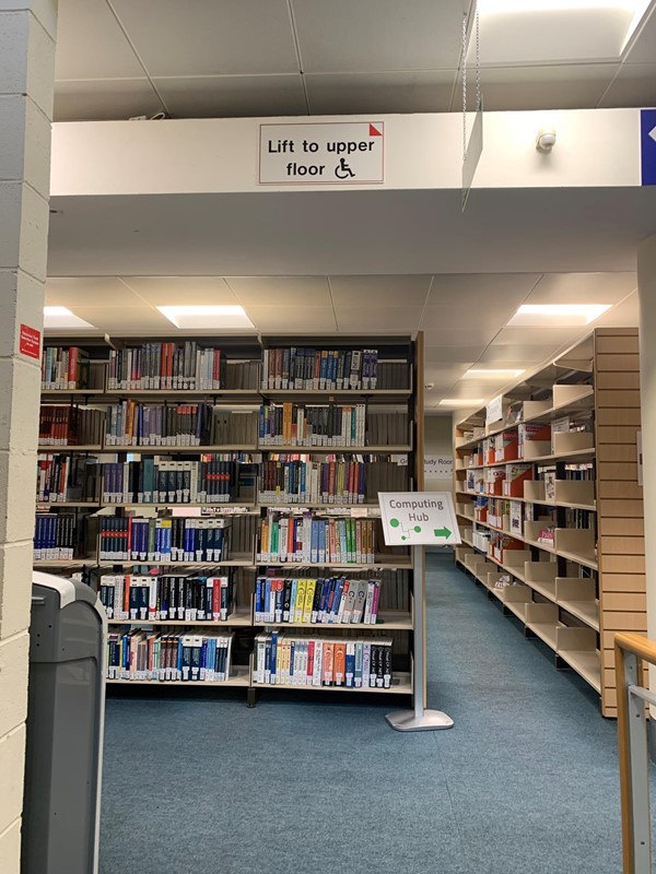 Catalogue and book area with sign for lift